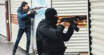 police officers point their guns towards the street